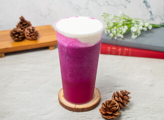 Dragon Cheese Milk ice tea served in disposable glass isolated on background top view of taiwan drink