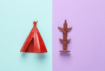 Native American Indians wigwam and idol on pastel background © splitov27