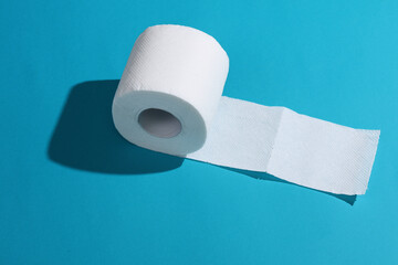 Roll of white toilet paper on a blue background