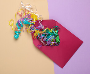 Festive invitation. Envelope with serpentine on a pastel background