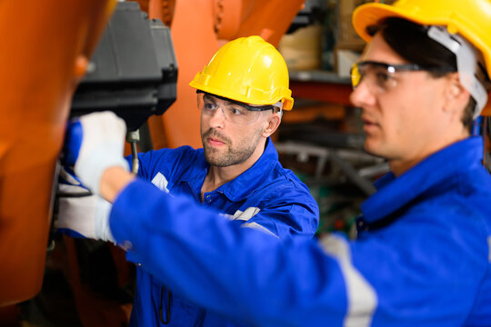 Maintenance Engineers Team Working Together At Industrial Factory