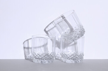 Empty glass on a gray white background with a shadow. Creative layout