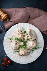 Manti with meat, spices and herbs in plate.
