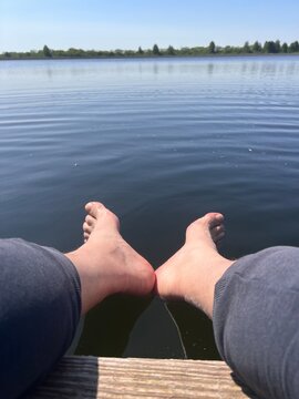 feet in the lake. Outdoors recreation and camping concept.