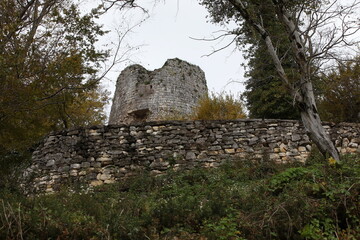 The remains of an ancient fortress with a stone wall.Background image of an old architectural structure