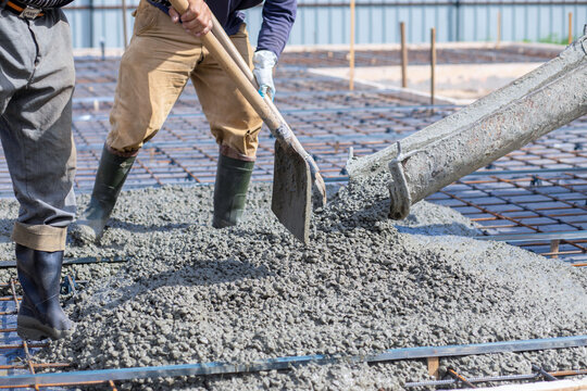 Spread concrete over the surface with shovels.