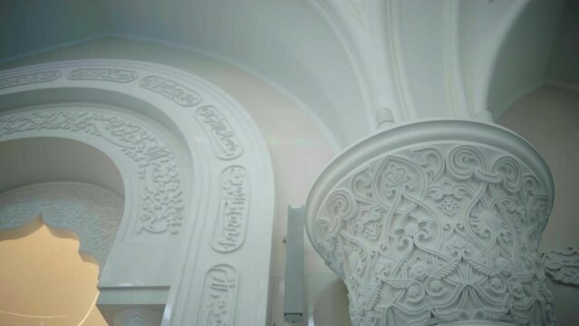 White painted columns. Scene. Beautiful architecture inside the room and beautiful carved patterns on the walls.