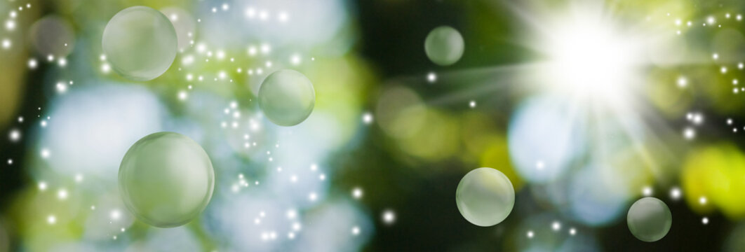  image of green blurred background with bokeh, bright flash of light and flying balls. Horizontal banner
