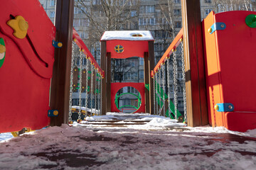 Bright colorful playground covered with snow. Empty playground in winter
