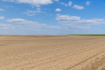 Fototapeta na wymiar plowed soil in the field in the spring season