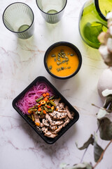 Rice noodles with chicken, carrots, peas, green beans, corn and sesame seeds with pumpkin cream soup.