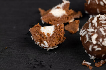 Chocolate candies in the form of balls with milk coconut