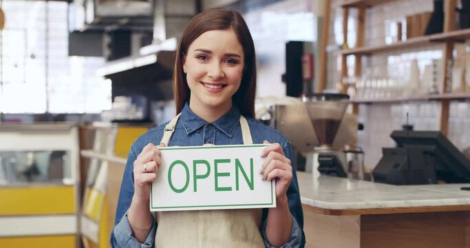 Happy woman, open sign and portrait of barista at cafe ready to serve in small business, owner or restaurant. Female person or waitress with smile holding billboard in opening store or coffee shop