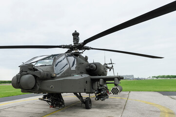 Naklejka na ściany i meble AH 64 Apache at a field airfield