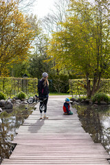 Child and mom in a big garden with water