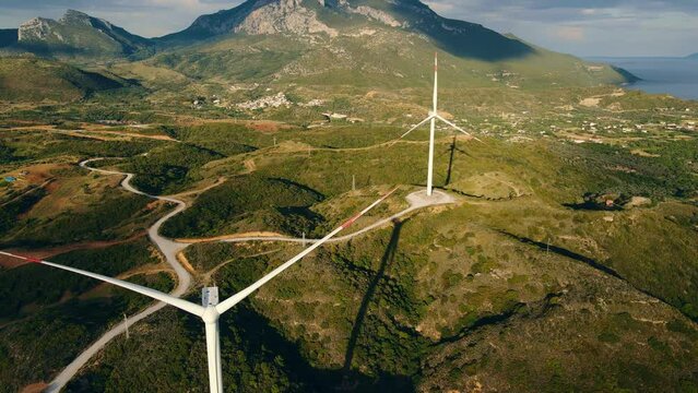 Wind turbine non rotation in wind power farm on windless overcast day, aerial shot