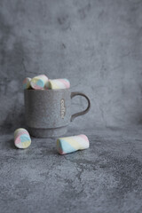 On a beautiful background, a mug with marshmallows. View from above.