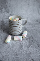 On a beautiful background, a mug with marshmallows. View from above.