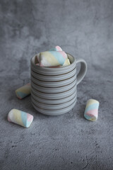 On a beautiful background, a mug with marshmallows. View from above.