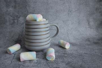 On a beautiful background, a mug with marshmallows. View from above.
