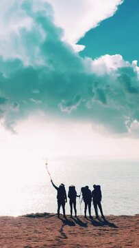 The travelers with fire stick standing on the mountain top above the sea