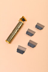 Fototapeta premium Electric hair trimmer on pink background.