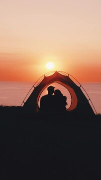 The romantic couple sitting in camping tent above the sea