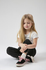 Studio portrait of beautiful little girl in black and white outfit white background