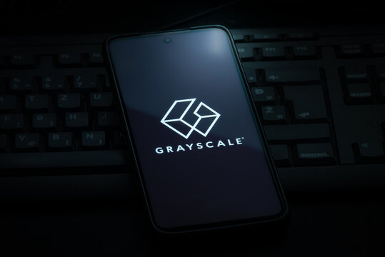 Ljubljana, Slovenia - 21 January 2023: Grayscale investing logo on smartphone screen laying on computer keyboard