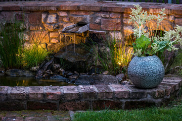 Water feature in a rustic wall in the evening