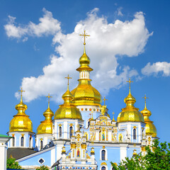 Fototapeta na wymiar Gold Domes of St. Michael's Cathedrall in Kiev against the blue sky