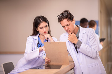 Medical staff analyzing and working at clinic hallway