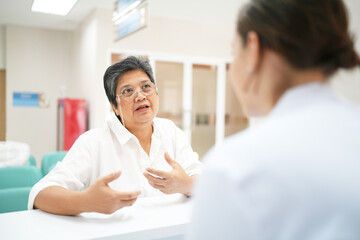 Attentive female doctor explains diagnosis to patient, gives professional consultancy