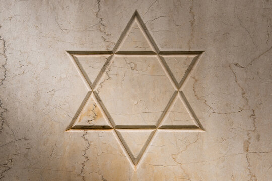 The star of David engraved on an old marble tombstone