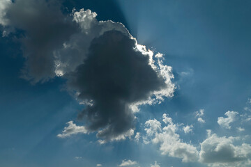 White puffy cumulus clouds on summer blue sky