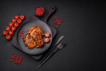 Delicious fried chicken in sauce with onions, salt, spices and herbs
