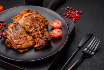 Delicious fried chicken in sauce with onions, salt, spices and herbs