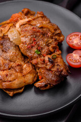 Delicious fried chicken in sauce with onions, salt, spices and herbs