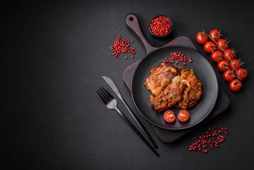 Delicious fried chicken in sauce with onions, salt, spices and herbs