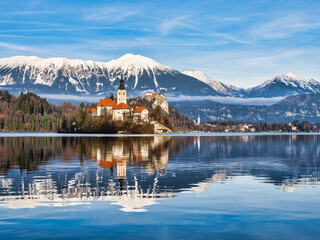 lake Bled island church, bled castle and snow peak mountains during a blue sky, Bled, Slovenia