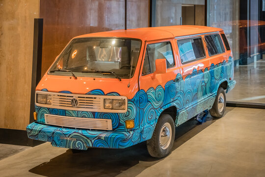 Calgary, AB, Canada-March 25, 2022:  Vintage 1960s VW kombi camper van or microbus painted in bright blue waves and orange .