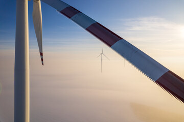 Aerial view of windfarm during winter foggy morning
