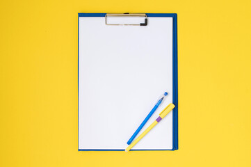 Vertical set of blue stationery as a template with a place to copy on a yellow table