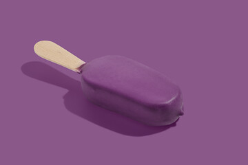 Purple ice cream on a stick on purple pastel background