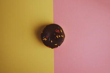 Donuts pattern. Top view. Colorful donuts with icing as background with copy space. Colorful glazed doughnuts with sprinkles.
