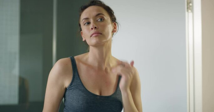 Skincare, health and woman checking her face for pimples, acne or pores in the mirror of her bathroom. Morning, beauty and young female person touching facial skin before treatment in her home.