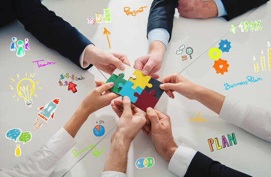 Teamwork of partners connect puzzle pieces as integration and startup