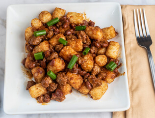 chili tots top with  green onions,