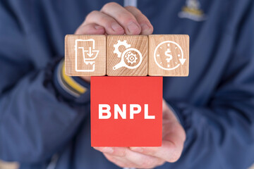 Man holding colorful blocks with icons and abbreviation: BNPL. Online Shopping Internet Retail E-commerce Technology. BNPL Buy Now Pay Later Concept.