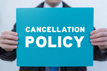 Businessman holding turquoise banner with inscription: CANCELLATION POLICY. Concept of business...